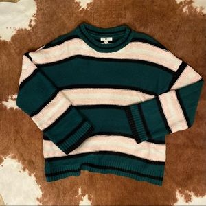 Green/black/pink/white striped oversized sweater.